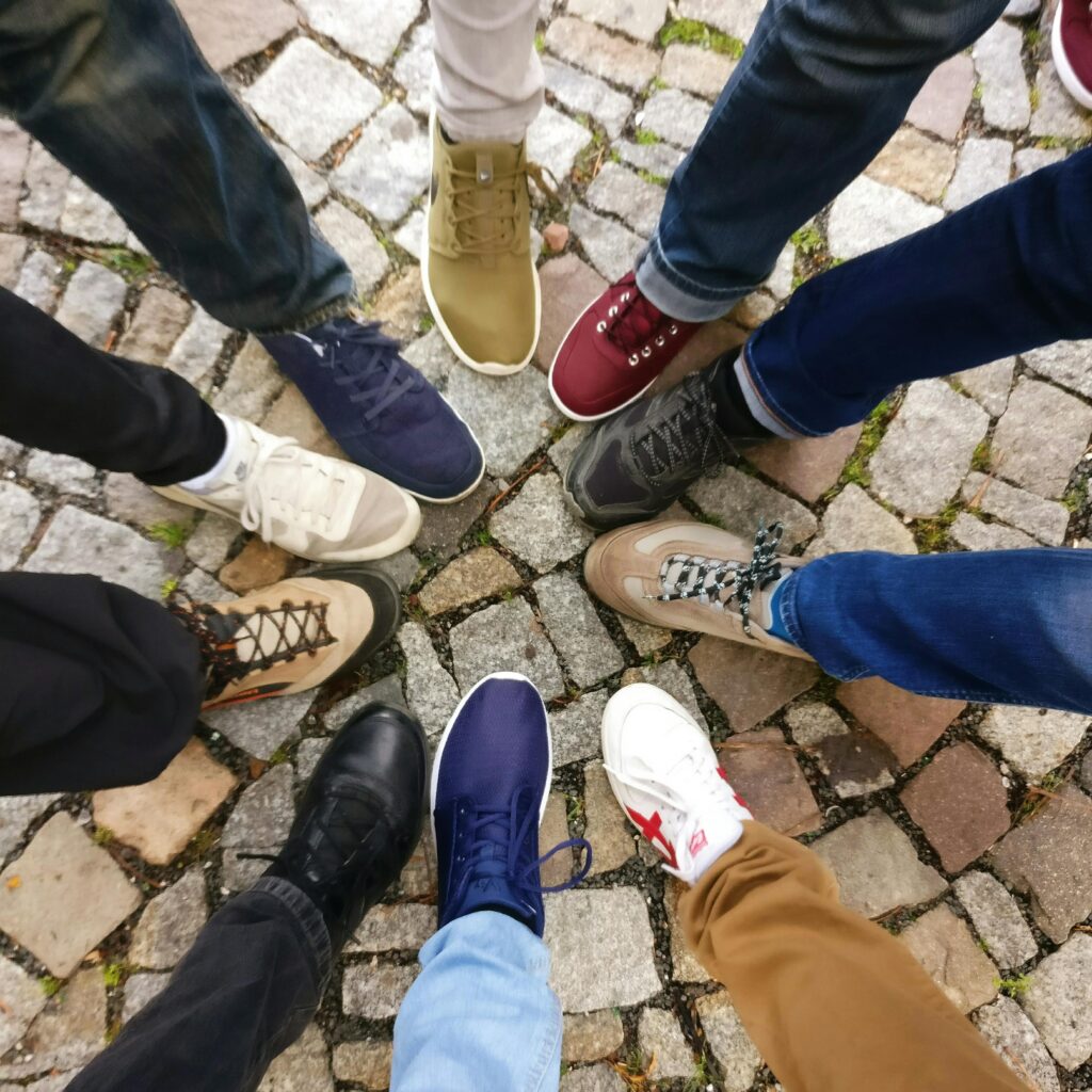 People Forming Round by Shoes